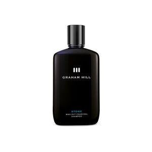 Schwarze Flasche STOWE WAX OUT CHARCOAL SHAMPOO von GRAHAM HILL mit schwarzem Verschluss und weisser Beschriftung.