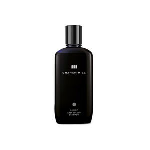 Farbpflegendes LOOP Grey Colour Shampoo von GRAHAM HILL in einer dunkelblauen 200-ml-Flasche mit schwarzem Verschluss.