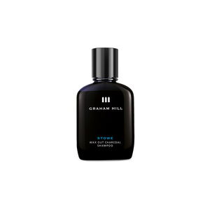 Schwarze 100-ml-Flasche STOWE WAX OUT CHARCOAL SHAMPOO von GRAHAM HILL mit schwarzem Verschluss und weisser Beschriftung.