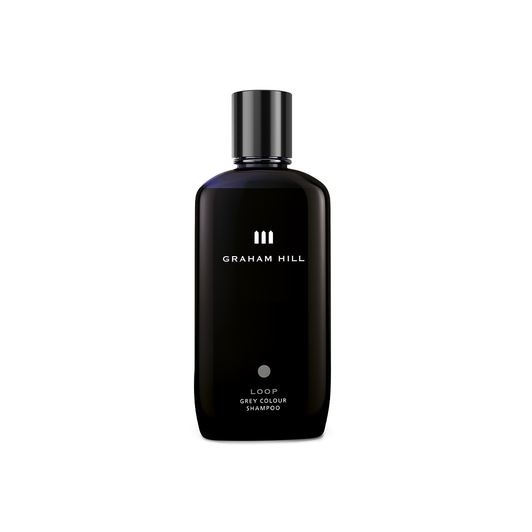 Farbpflegendes LOOP Grey Colour Shampoo von GRAHAM HILL in einer dunkelblauen 200-ml-Flasche mit schwarzem Verschluss.