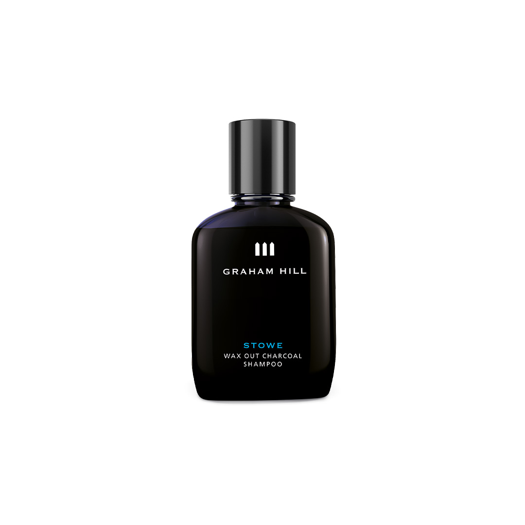 Schwarze 100-ml-Flasche STOWE WAX OUT CHARCOAL SHAMPOO von GRAHAM HILL mit schwarzem Verschluss und weisser Beschriftung.